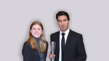 Two students holding an award