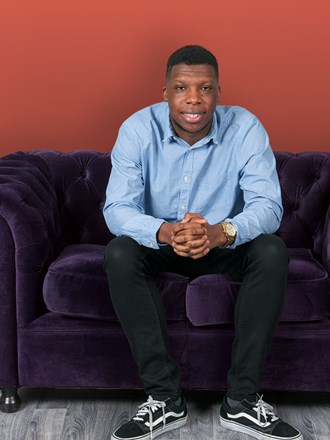 University of Law student sitting on a sofa University of Law student sitting on a sofa