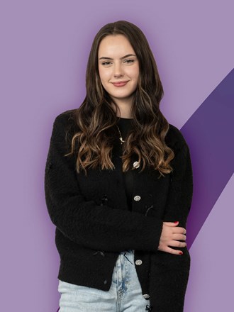 Smiling student on a purple coloured background Smiling student on a purple coloured background