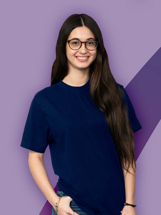 Smiling student on a purple coloured background Smiling student on a purple coloured background