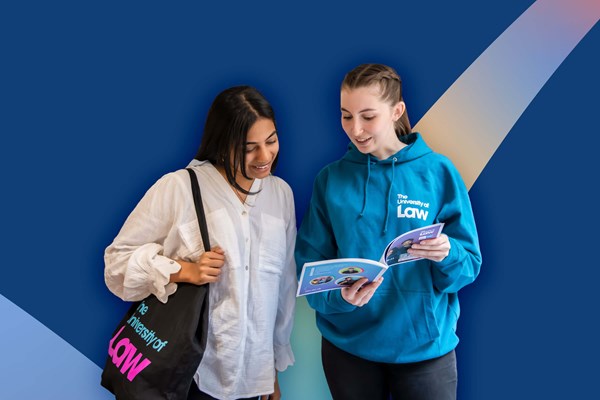 Two females looking at one of our printed publications Two females looking at one of our printed publications