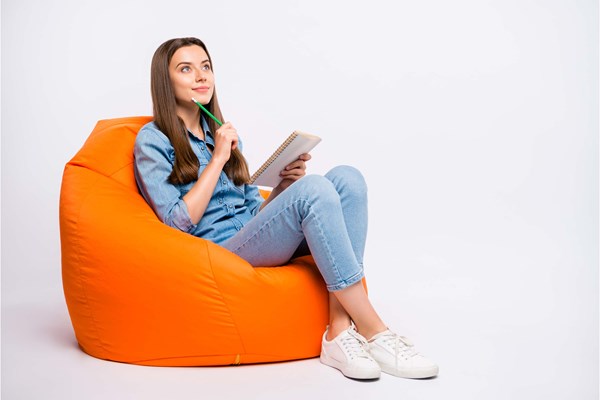 Student contributor sat on orange bean bag