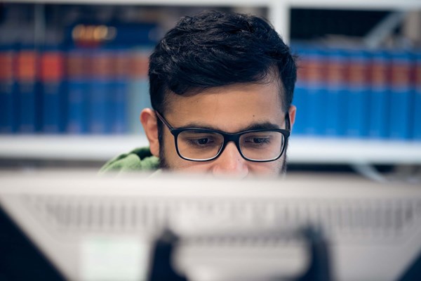 Male student studying in library Male student studying in library